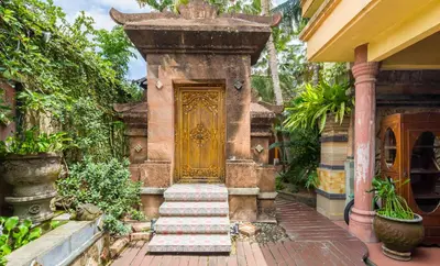 an entrance to a house with a gold door at Classic Malay House in KL City Centre in Kuala Lumpur