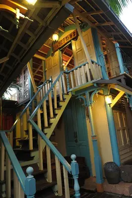 a building with a spiral staircase in front of it at Classic Malay House in KL City Centre in Kuala Lumpur