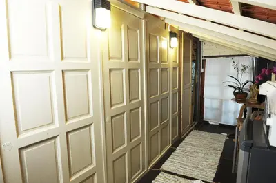 a hallway with a garage door and a rug at Classic Malay House in KL City Centre in Kuala Lumpur