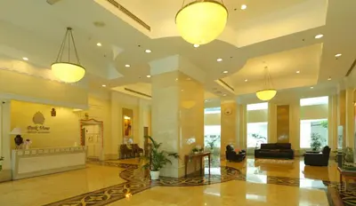 a lobby of a hotel with two lights at Parkview Service Apartments in Kuala Lumpur