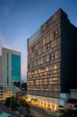 a tall building with lights on in a city at Hotel Stripes Kuala Lumpur, Autograph Collection in Kuala Lumpur