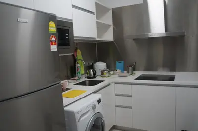 a kitchen with a washer and a sink and a dishwasher at M City Lake View KLCCAmpang in Kuala Lumpur