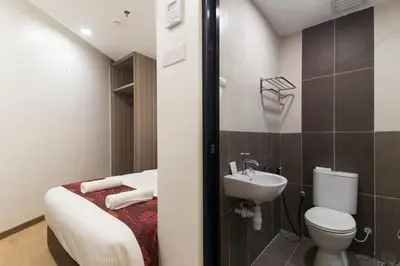 a small bathroom with a toilet and a sink at Signature International Hotel China Town in Kuala Lumpur