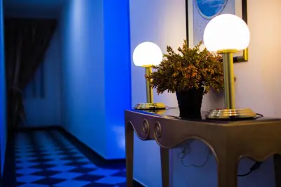 a table with two lamps and a plant on it at Akar Hotel Jalan TAR in Kuala Lumpur