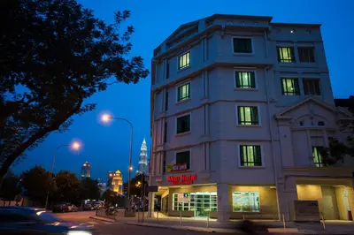 a building on a city street at night at Akar Hotel Jalan TAR in Kuala Lumpur