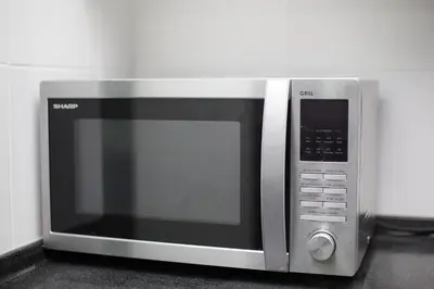 a microwave oven sitting on top of a counter at Binjai 8 KLCC by PSM Luxury Suites in Kuala Lumpur