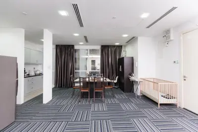 a dining room with a table and a kitchen at Binjai 8 KLCC by PSM Luxury Suites in Kuala Lumpur