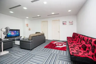 a living room with a couch and a flat screen tv at Binjai 8 KLCC by PSM Luxury Suites in Kuala Lumpur