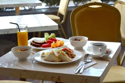 a table with two plates of breakfast food and drinks at InnB Park Hotel in Kuala Lumpur