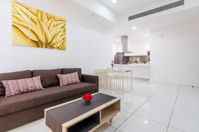 a living room with a couch and a coffee table at Five Senses Suite in M Suite KLCC in Kuala Lumpur