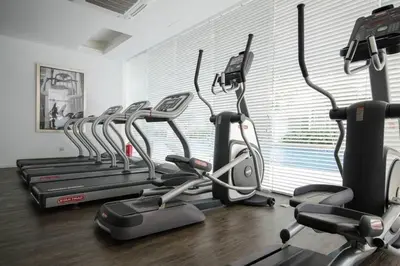 a gym with several cardio machines in a room at Five Senses Suite in M Suite KLCC in Kuala Lumpur