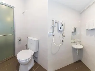 a bathroom with a toilet and a sink at Fumah Hotel Jalan Kuching in Kuala Lumpur