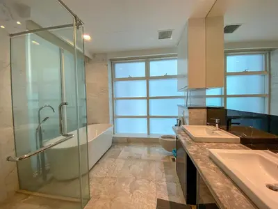 a bathroom with two sinks and a glass shower at The Platinum Kuala Lumpur by LUMA in Kuala Lumpur