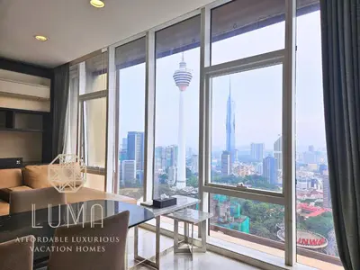 a room with a large window with a view of the city at The Platinum Kuala Lumpur by LUMA in Kuala Lumpur
