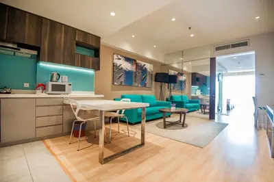 a kitchen and living room with a table and chairs at D'Majestic Place by Widebed in Kuala Lumpur