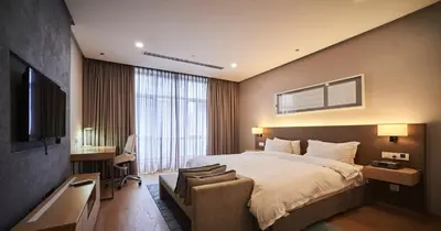 a hotel room with a bed and a television at 188 Suites by NamaStay in Kuala Lumpur