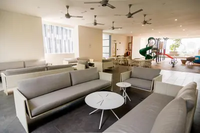 a living room with couches and tables in a building at 188 Suites by NamaStay in Kuala Lumpur