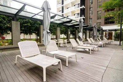 a row of chairs and umbrellas on a deck at 188 Suites by NamaStay in Kuala Lumpur