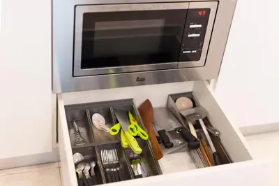 a drawer with scissors and other kitchen utensils at Soho Suites KLCC by Leala in Kuala Lumpur