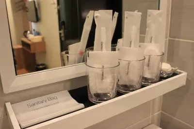 a shelf with three glasses on it in a bathroom at BIG M Hotel in Kuala Lumpur