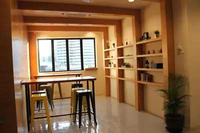 a dining room with a table and chairs and a window at BIG M Hotel in Kuala Lumpur