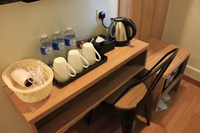 a wooden table with bottles of water and shoes on it at BIG M Hotel in Kuala Lumpur