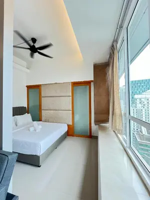 a bedroom with a bed and a ceiling fan at Parkview Suite KLCC, Bernice in Kuala Lumpur