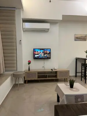 a living room with a flat screen tv on the wall at Parkview Suite KLCC, Bernice in Kuala Lumpur