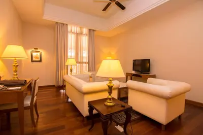 a living room with two couches and a tv at Royale Chulan Kuala Lumpur in Kuala Lumpur