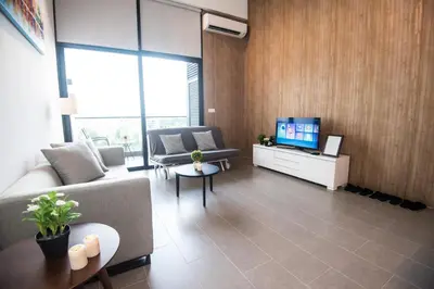 a living room with a couch and a tv at KL Sentral Bangsar Suites (EST) by Luxury Suites Asia in Kuala Lumpur