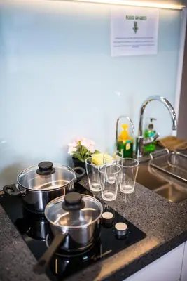 a kitchen counter with pots and pans on a stove at KL Sentral Bangsar Suites (EST) by Luxury Suites Asia in Kuala Lumpur