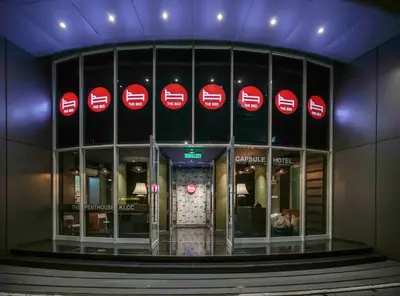 a building with red signs on the side of it at The Bed KLCC in Kuala Lumpur