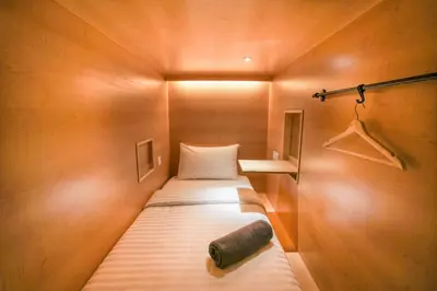 a small room with a bed in a wooden wall at The Bed KLCC in Kuala Lumpur
