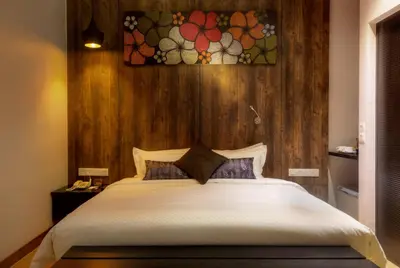 a bedroom with a large bed with a wooden wall at Hotel Twenty 8B in Kuala Lumpur