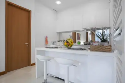 a white kitchen with a counter with fruits on it at Soho Suites KLCC by 21 Century travel in Kuala Lumpur