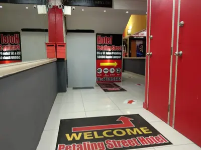 a hallway with a welcome mat on the floor in a store at Petaling Street Hotel Chinatown in Kuala Lumpur