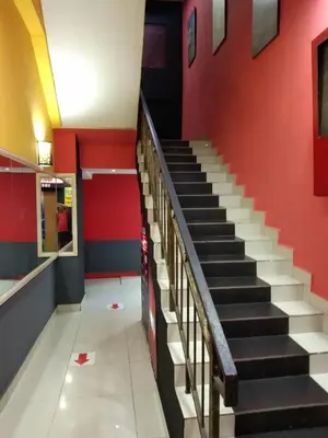 a staircase in a building with a red wall at Petaling Street Hotel Chinatown in Kuala Lumpur