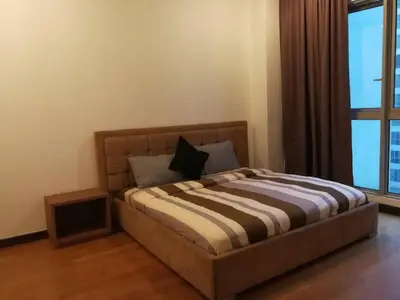 a bed in a room with a large window at Suites & Residences @ Regalia by PLC in Kuala Lumpur