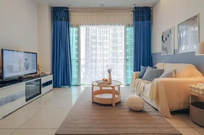 a living room with a couch and a tv at Suites & Residences @ Regalia by PLC in Kuala Lumpur