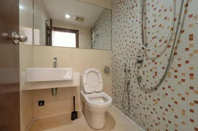 a bathroom with a toilet and a sink and a shower at Suites & Residences @ Regalia by PLC in Kuala Lumpur