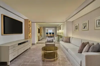 a living room with a couch and a tv at Sheraton Imperial Kuala Lumpur Hotel in Kuala Lumpur