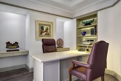 a home office with a desk and two chairs at Sheraton Imperial Kuala Lumpur Hotel in Kuala Lumpur