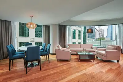 a living room with a couch and a table and chairs at The Westin Kuala Lumpur in Kuala Lumpur