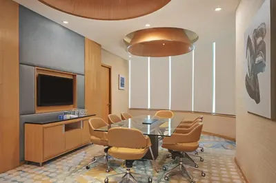 a conference room with a table and chairs and a television at The Westin Kuala Lumpur in Kuala Lumpur