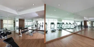a gym with treadmills and ellipticals in a building at Maytower Service Suite - Masjid India in Kuala Lumpur