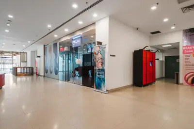 a lobby with a large glass door in a building at Summer Suites KLCC Apartments by soulasia in Kuala Lumpur