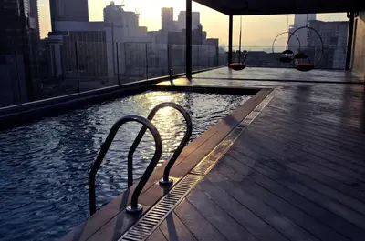 a swimming pool on a building with a view of the city at MOV Hotel Kuala Lumpur in Kuala Lumpur