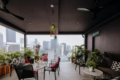 a restaurant with tables and chairs and a view of the city at MOV Hotel Kuala Lumpur in Kuala Lumpur