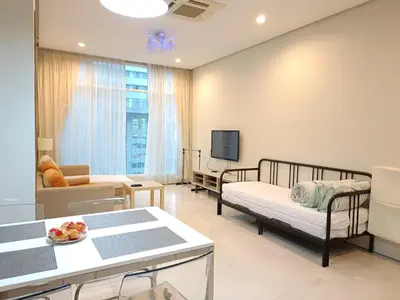 a living room with two beds and a tv at Soho Suites KLCC by LX Suites 2 in Kuala Lumpur