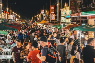 a crowd of people walking through a market at night at Kingston Hotel 1 - Bukit Bintang in Kuala Lumpur